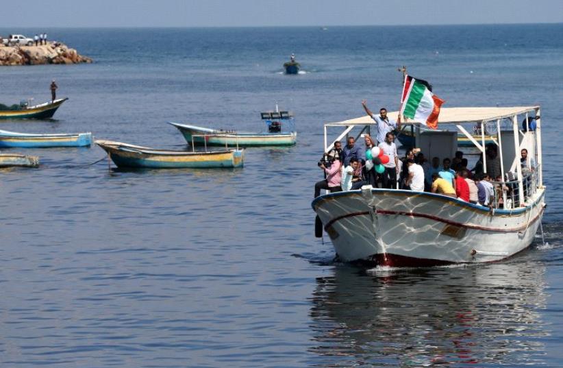 Palestinians ride a boat as they take part in a rally to show solidarity with Gaza-bound flotilla October 5, 2016. (photo credit: REUTERS)