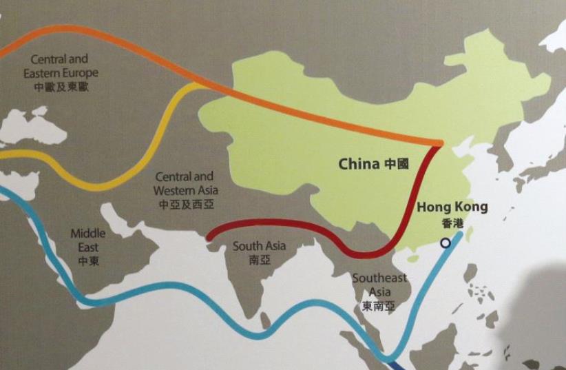 THE SHADOW of a participant is seen on a map illustrating China’s ‘One Belt, One Road’ megaproject at the Asian Financial Forum in Hong Kong earlier this year. (photo credit: REUTERS)