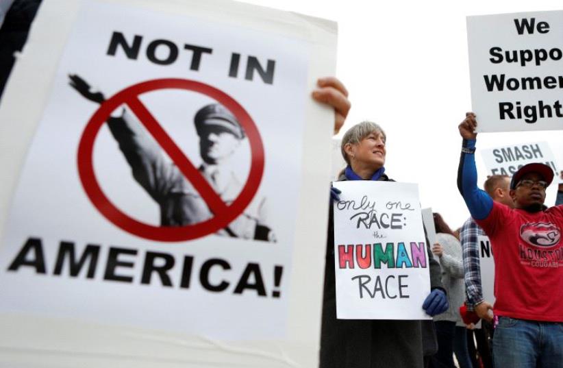 People protest on the day white nationalist leader Richard Spencer of the National Policy Institute is due to speak on campus at an event not sanctioned by the school, at Texas A&M University in College Station, Texas (photo credit: REUTERS)