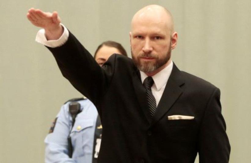 Anders Behring Breivik raises his right hand during the appeal case in Borgarting Court of Appeal at Telemark prison in Skien (photo credit: REUTERS)