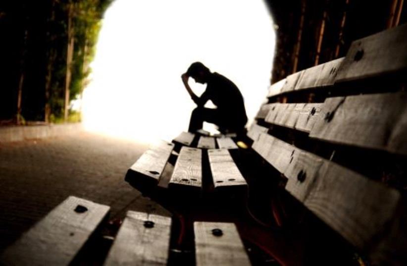 Depressed person broods in tunnel (photo credit: INGIMAGE)