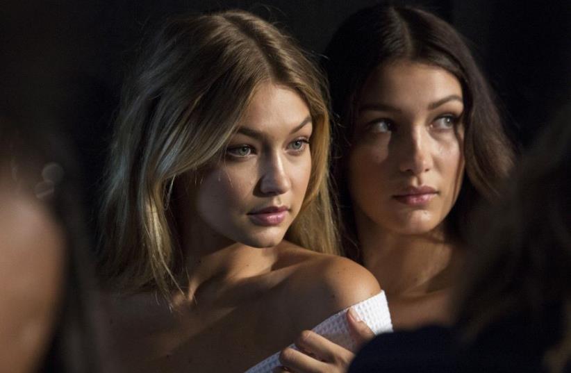 Models Gigi Hadid (L) and Bella Hadid pose for photos (photo credit: REUTERS)