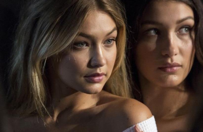 Models Gigi Hadid (L) and Bella Hadid pose for photos (photo credit: REUTERS)