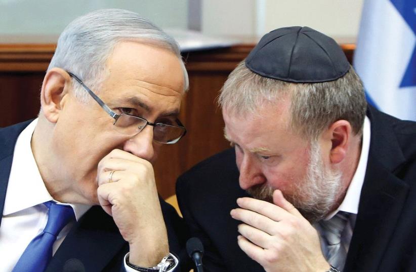 PRIME MINISTER BENJAMIN NETANYAHU consults with Avichai Mandelblit. (photo credit: REUTERS)