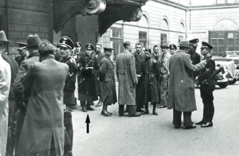 Police and SS, including Adolf Eichmann (see arrow), gather in a courtyard before the start of the round-up of the Jewish community in Vienna on March 18, 1938 (photo credit: DOCUMENTATION CENTER OF AUSTRIAN RESISTANCE)