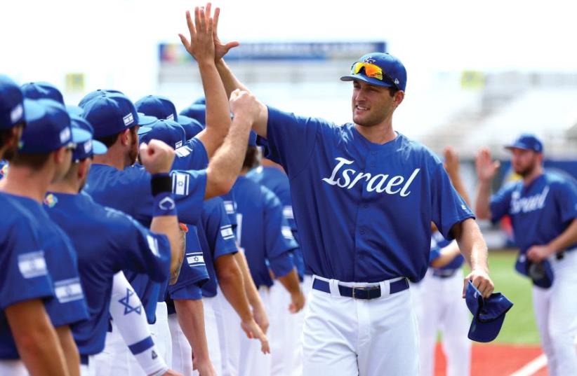 Nate Freiman high-fives his teammates during player introductions at a 2016 World Baseball Classic Qualifier at MCU Park in Brooklyn in September (photo credit: ALEX TRAUTWIG / MLB PHOTOS VIA GETTY IMAGES)