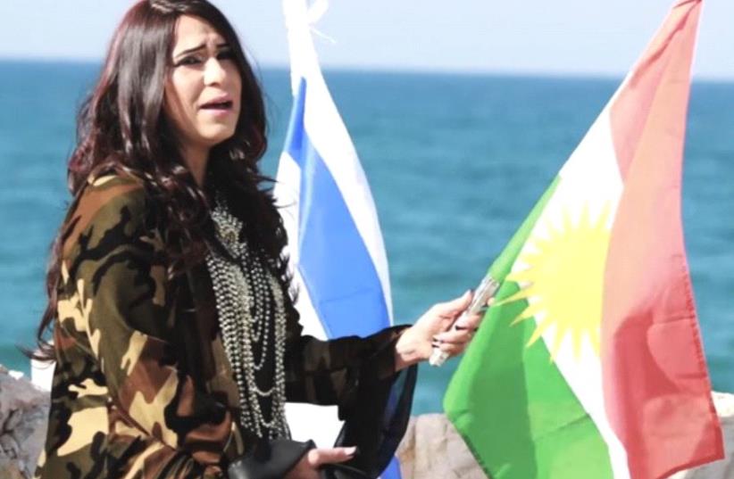 Hadassa Yeshurun holds Kurdish and Israeli flags in her music video (photo credit: YOUTUBE SCREENSHOT)