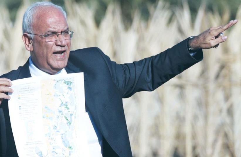 SENIOR PLO OFFICIAL Saeb Erekat speaks to reporters about Israeli appropriation of West Bank land, near Jericho last year. (photo credit: REUTERS)