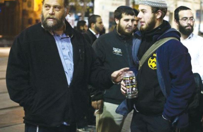 Ben-Zion Gopstein (left), leader of the group Lehava, gathers with some of his young followers in Jerusalem in 2014 (photo credit: REUTERS)