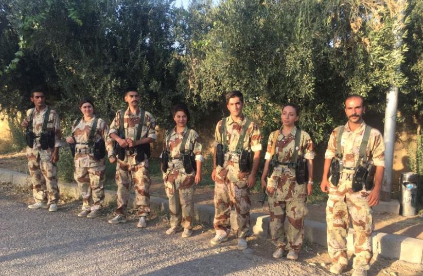 MEMBERS OF the Iranian-Kurdish Democratic Party of Iranian Kurdistan stand at attention at one of their bases (photo credit: Courtesy)