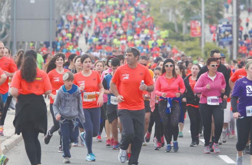 Runners in the 2016 Jerusalem Marathon jog uphill ahead of some 25,000 others who took part in the event (photo credit: MARC ISRAEL SELLEM/THE JERUSALEM POST)