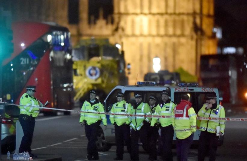 Police officers work at the scene after an attack on Westminster Bridge in London, Britain, March 22, 2017 (photo credit: REUTERS)