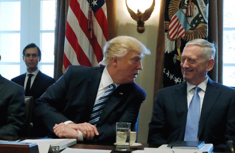 US PRESIDENT Donald Trump is flanked by Secretary of State Rex Tillerson (left) and Defense Secretary James Mattis at the White House (photo credit: REUTERS)