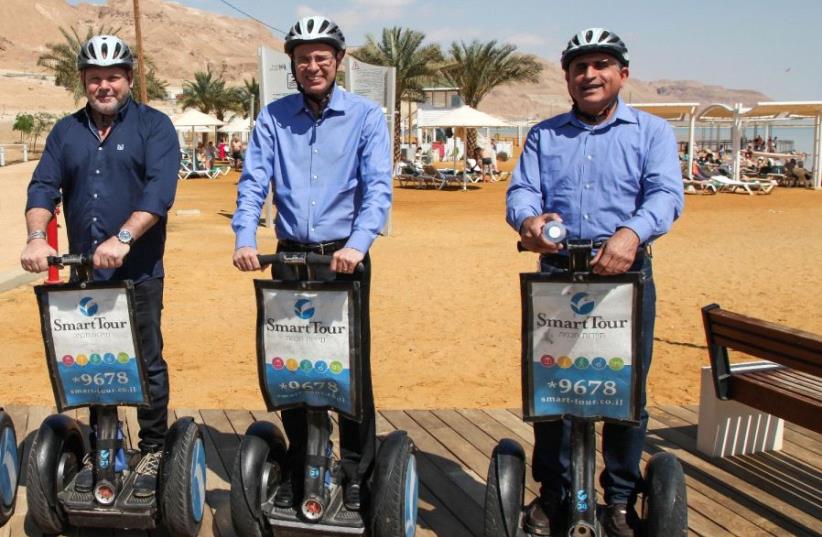 Tourism Minister Yariv Levin (center) rides a Segway Monday morning down a recently completed 3 km.-long promenade off the coast of the Dead Sea.  (photo credit: TOURISM MINISTRY)