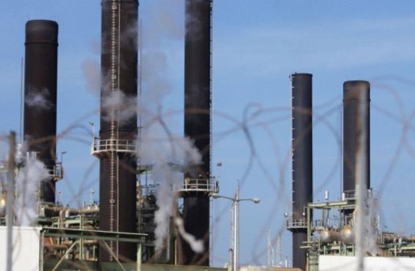 A view shows Gaza's power plant through a barbed fence in the central Gaza Strip January 16, 2017 (photo credit: REUTERS)