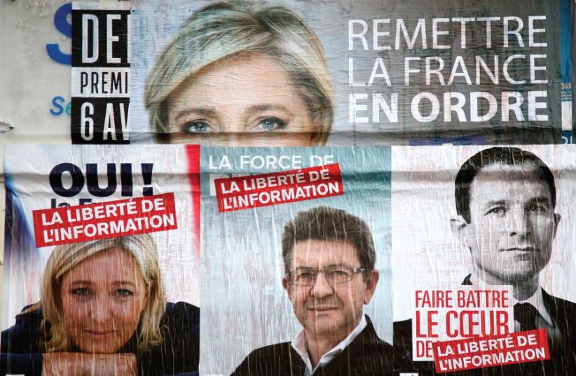 CAMPAIGN POSTERS for candidates Marine Le Pen of the National Front (FN), Jean-Luc Melenchon of the Parti de Gauche, and Benoit Hamon of the Socialist Party who were running in the 2017 French presidential election (photo credit: REUTERS)