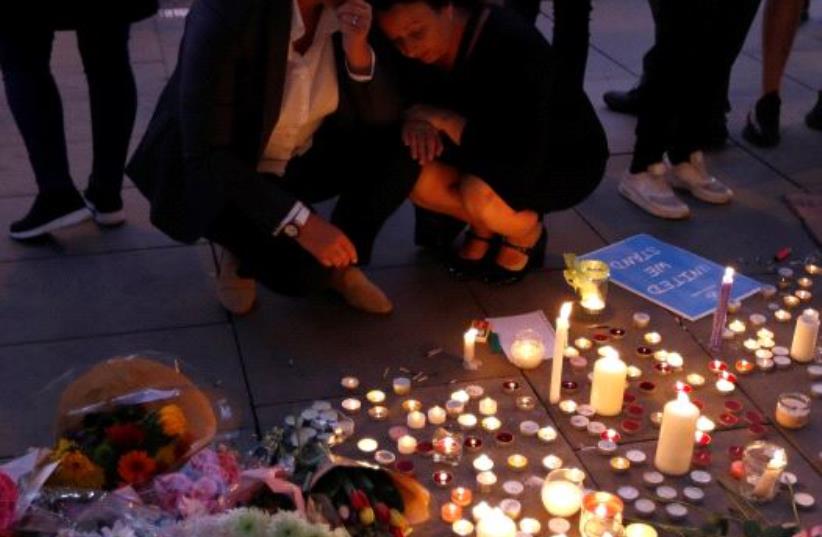 People pay their respects to the victims of the deadly suicide bombing in Manchester that took place during an Ariana Grande concert.  (photo credit: REUTERS)