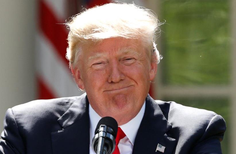 US President Donald Trump pauses as he announces his decision that the United States will withdraw from the landmark Paris Climate Agreement, in the Rose Garden of the White House in Washington, US, June 1, 2017. (photo credit: KEVIN LAMARQUE/REUTERS)