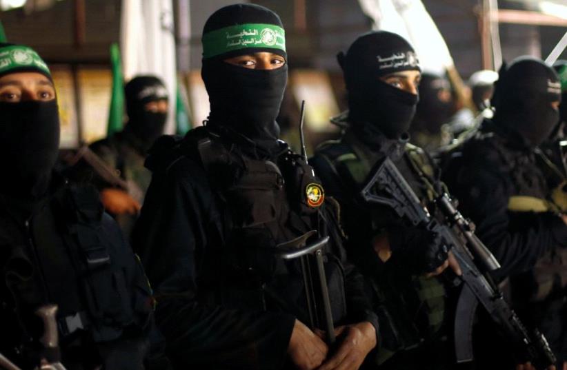 Palestinian Hamas militants take part in a memorial service for senior militant Mazen Fuqaha, in Gaza City March 27, 2017. (photo credit: REUTERS/MOHAMMED SALEM)