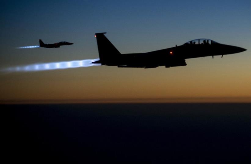 A pair of US Air Force F-15E Strike Eagles fly over northern Iraq after conducting airstrikes in Syria (photo credit: REUTERS)