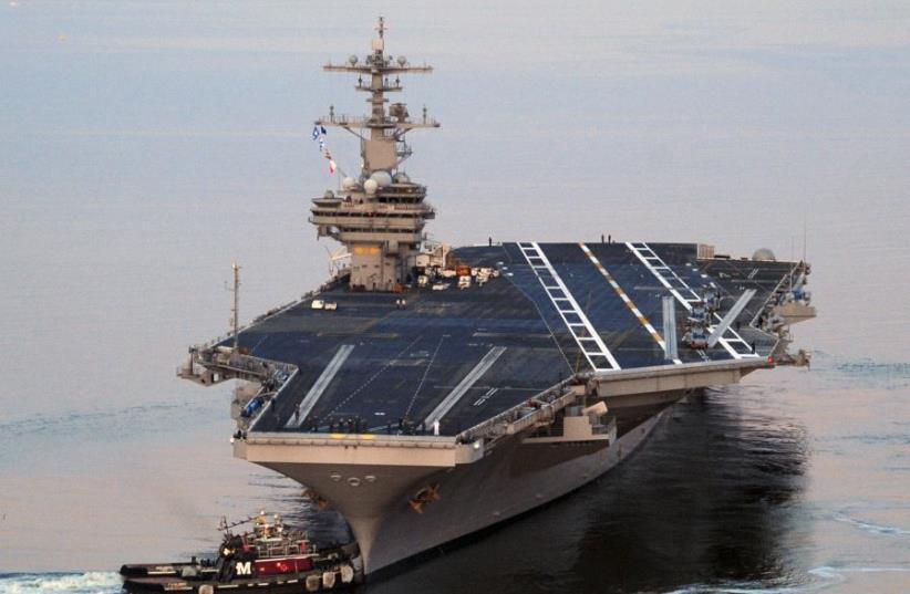 The Nimitz-class aircraft carrier USS George H.W. Bush (CVN 77) departs Naval Station Norfolk, Virginia, for its maiden deployment, May 11, 2011. (photo credit: REUTERS/NICHOLAS HALL/U.S. NAVY/HANDOUT)