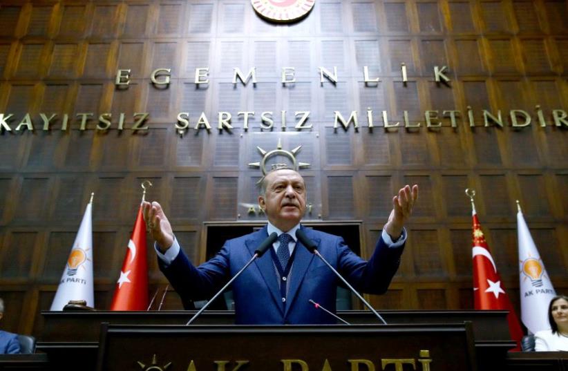 Turkish President Tayyip Erdogan addresses members of parliament from his ruling AK Party (AKP) during a meeting at the Turkish parliament in Ankara, Turkey, June 13, 2017.  (photo credit: KAYHAN OZER/PRESIDENTIAL PALACE/HANDOUT VIA REUTERS)