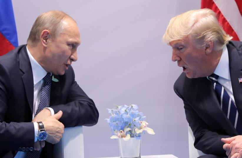 U.S. President Donald Trump speaks with Russian President Vladimir Putin during the their bilateral meeting at the G20 summit in Hamburg, Germany July 7, 2017. (photo credit: REUTERS/CARLOS BARRIA)