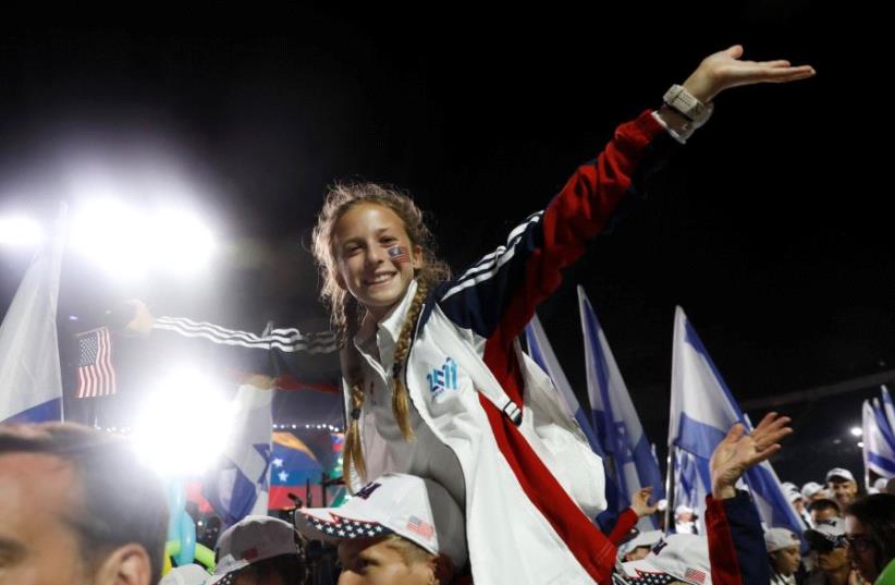 Delegations take part in the opening ceremony of the 20th Maccabiah Games, a quadrennial Jewish sports extravaganza which takes place in Israel, at Teddy Stadium in Jerusalem July 6, 2017. (photo credit: RONEN ZVULUN / REUTERS)