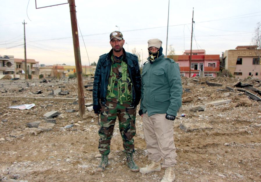 Fighters from the Shi’ite dominated PMU militia are seen in the devastated Hay al-Arabi neighborhood in early January (photo credit: JONATHAN SPYER)