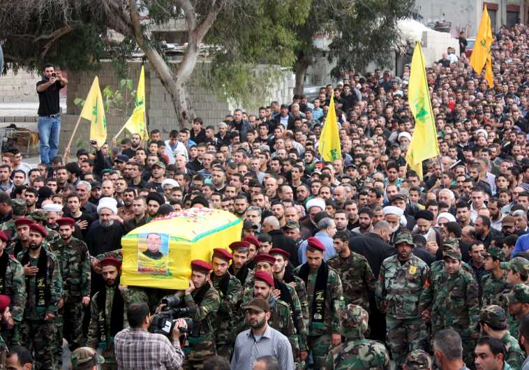 Hezbollah members in Lebanon take part in a funeral procession for their comrade Akram Sadek Hourani, who was killed in the recent battles in Syria's Qalamoun region. (credit: REUTERS)