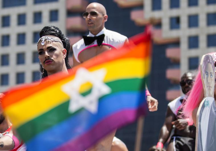 Israeli drag queens and go-go dancers dance on a truck during the annual gay pride parade in the Israeli coastal city of Tel Aviv on June 13, 2014.  (credit: JACK GUEZ / AFP)