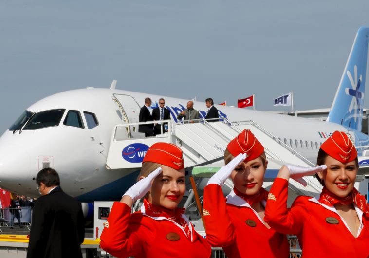 Cabin crew members of Russian carrier Aeroflot pose in front of a Sukhoi Superjet 100 airplane during a photo session at the 51st Paris Air Show at Le Bourget airport near Paris (credit: REUTERS)
