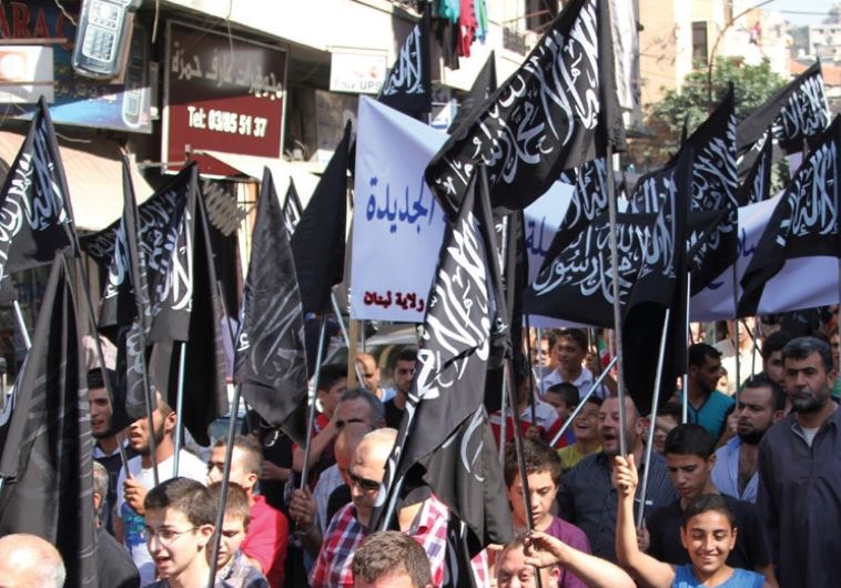 Members and supporters of the Islamist party Hizb Ut-Tahrir rally in Tripoli, northern Lebanon, in support of Palestinians and against Russian and US intervention in Syria, October 16 (credit: OMAR IBRAHIM / REUTERS)