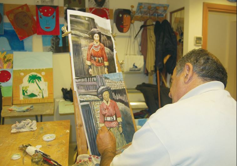 A man participate in an social art club offered by NATAL at its center in Tel Aviv. (credit: NATAL)