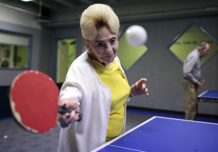 Holocaust survivor Betty Stein, 92, (L) and Eli Boyer, 91, play ping pong at a program for people with Alzheimer's and dementia at the Arthur Gilbert table tennis center in Los AngelesREUTERS