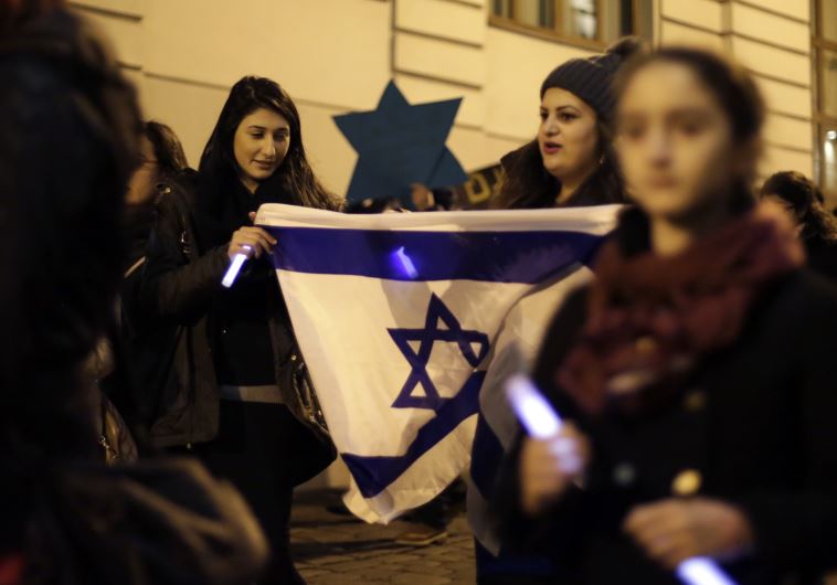 Members of the young Jewish community attend a commemoration ceremony for Holocaust victims in front of the synagogue in Vienna [File] (credit: REUTERS)