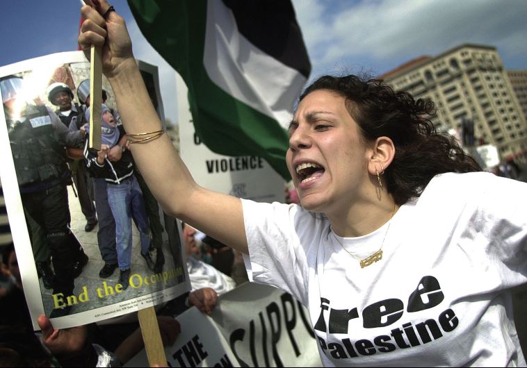 Zeina Ashrawi, of the Students for Justice in Palestine Society of George Mason University, participates in an anti-Israel rally in Washington, DC (credit: JIM WATSON / AFP)