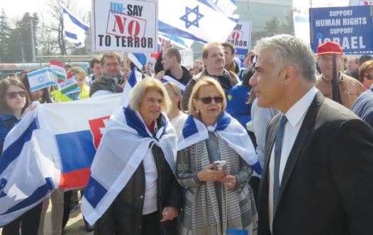 Yesh Atid Chairman Yair Lapid attends a pro-Israel rally in front of the UN Human Rights Council in Geneva in March (credit: YESH ATID)