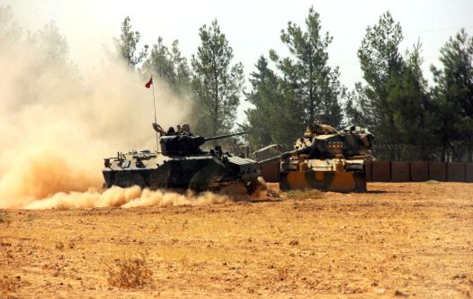 A Turkish army tank and an armoured vehicle are stationed near the Turkish-Syrian border in Karkamis in the southeastern Gaziantep province, Turkey, August 23, 2016 (credit: REUTERS)