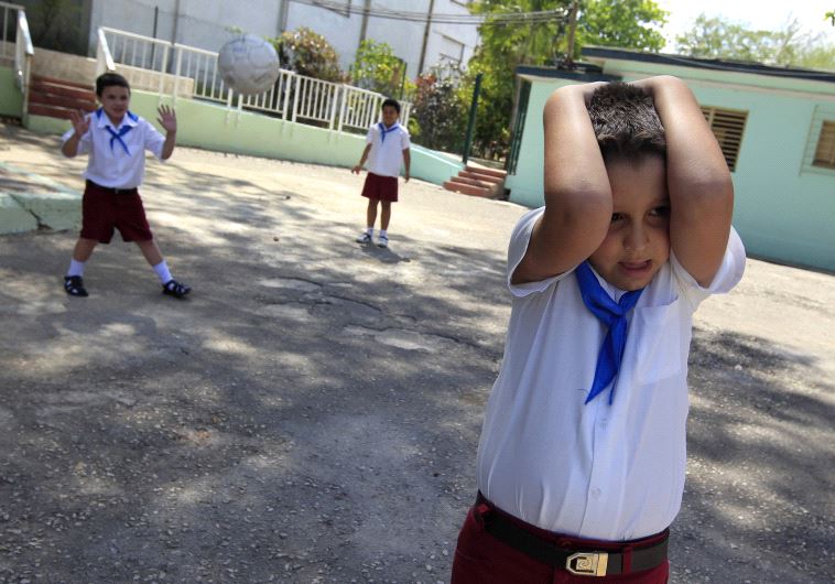 A child with autism plays with other children (file) (credit: REUTERS)