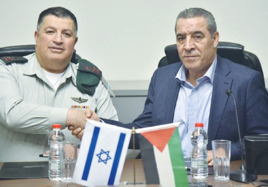 MAJ.-GEN. YOAV (POLY) MORDECHAI (left) shakes hands with Palestinian Authority Civil Affairs Minister Hussein al-Sheikh after agreeing to renew activities of the Joint Water Committee. (credit: COGAT)