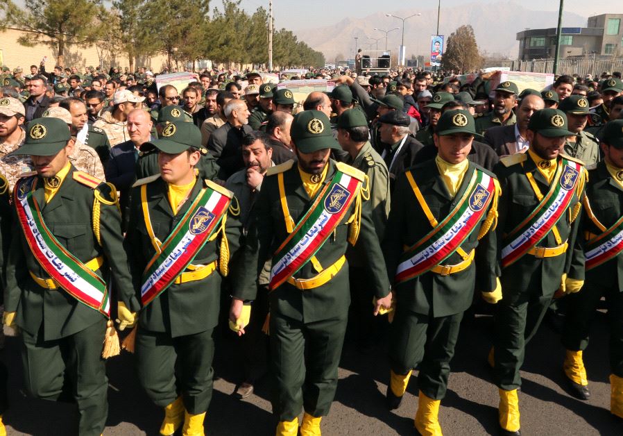 Iranian Revolutionary Guard members in Tehran carry the casket of Iran Revolutionary Guards Brigadier General Mohsen Ghajarian, who was killed in the northern province of Aleppo , Syria  (credit: ATTA KENARE / AFP)