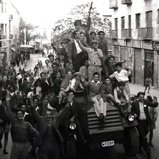 JEWS CROWD onto a British army armored car as they celebrate in downtown Jerusalem the morning after the United Nations voted to partition British mandate Palestine into a Jewish and an Arab state. (credit: REUTERS)