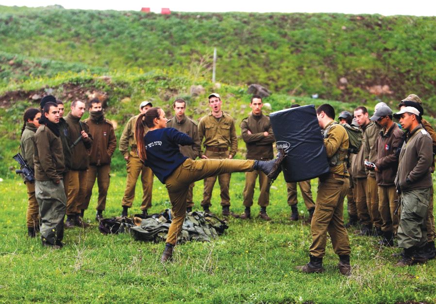 A FEMALE officer demonstrates a move a during a training session in Krav Maga, an Israeli self-defense technique, at a military base on the Golan Heights on March 1. (credit: REUTERS)