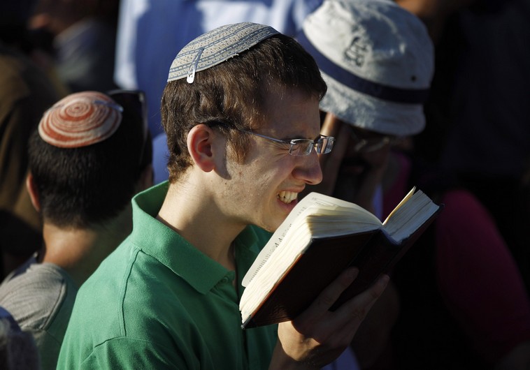 A Jewish youth prays during the joint funeral of three Israeli teens who were abducted and killed in the occupied West Bank, in the Israeli city of Modi'in