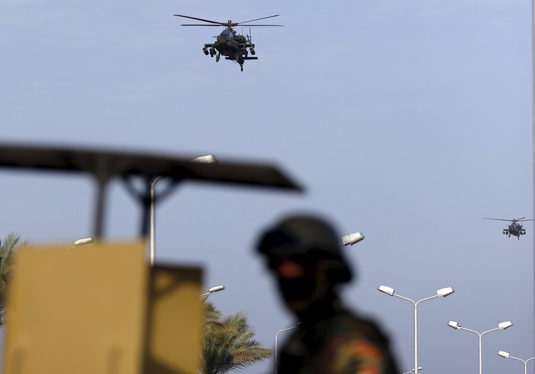 Egyptian military helicopters fly over a republican guard around the congress hall during the Arab Summit in Sharm el-Sheikh, in the South Sinai governorate, south of Cairo, March 28