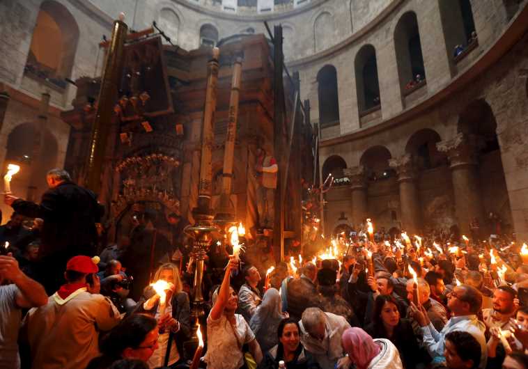 Worshippers hold candles as they take part in the Christian Orthodox Holy Fire ceremony at the Church of the Holy Sepulchre in Jerusalem