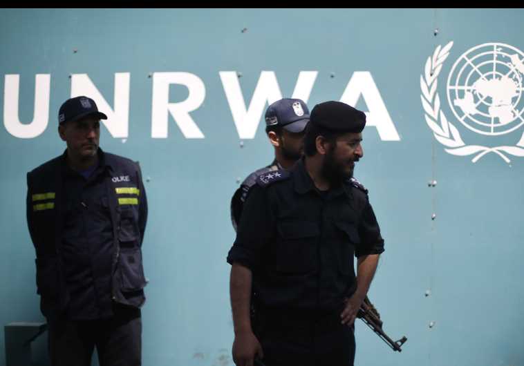 Palestinian policemen loyal to Hamas guard outside the UNRWA headquarters in Gaza City
