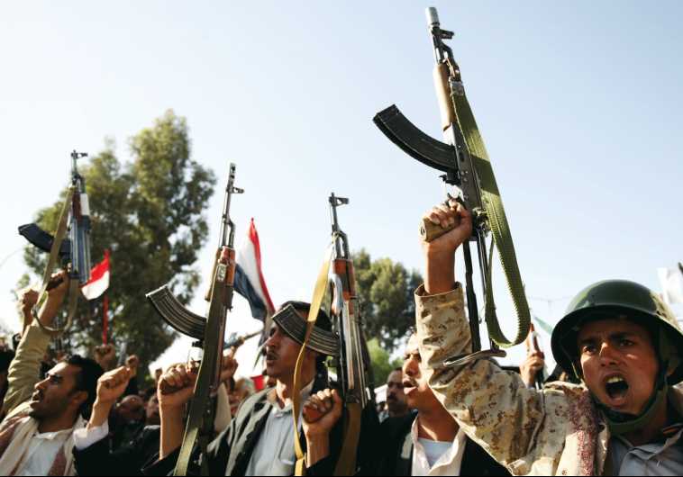 Houthi fighters raise their weapons as they demonstrate against an arms embargo imposed by the UN Security Council on the group, in Yemen’s capital of Sanaa last week.