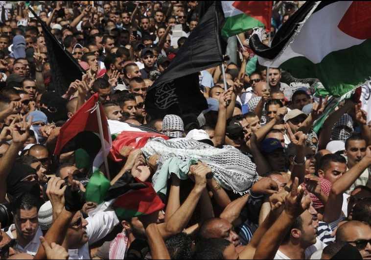 Palestinians carry the body of 16-year-old Muhammad Abu Khdeir during his funeral in Shuafat
